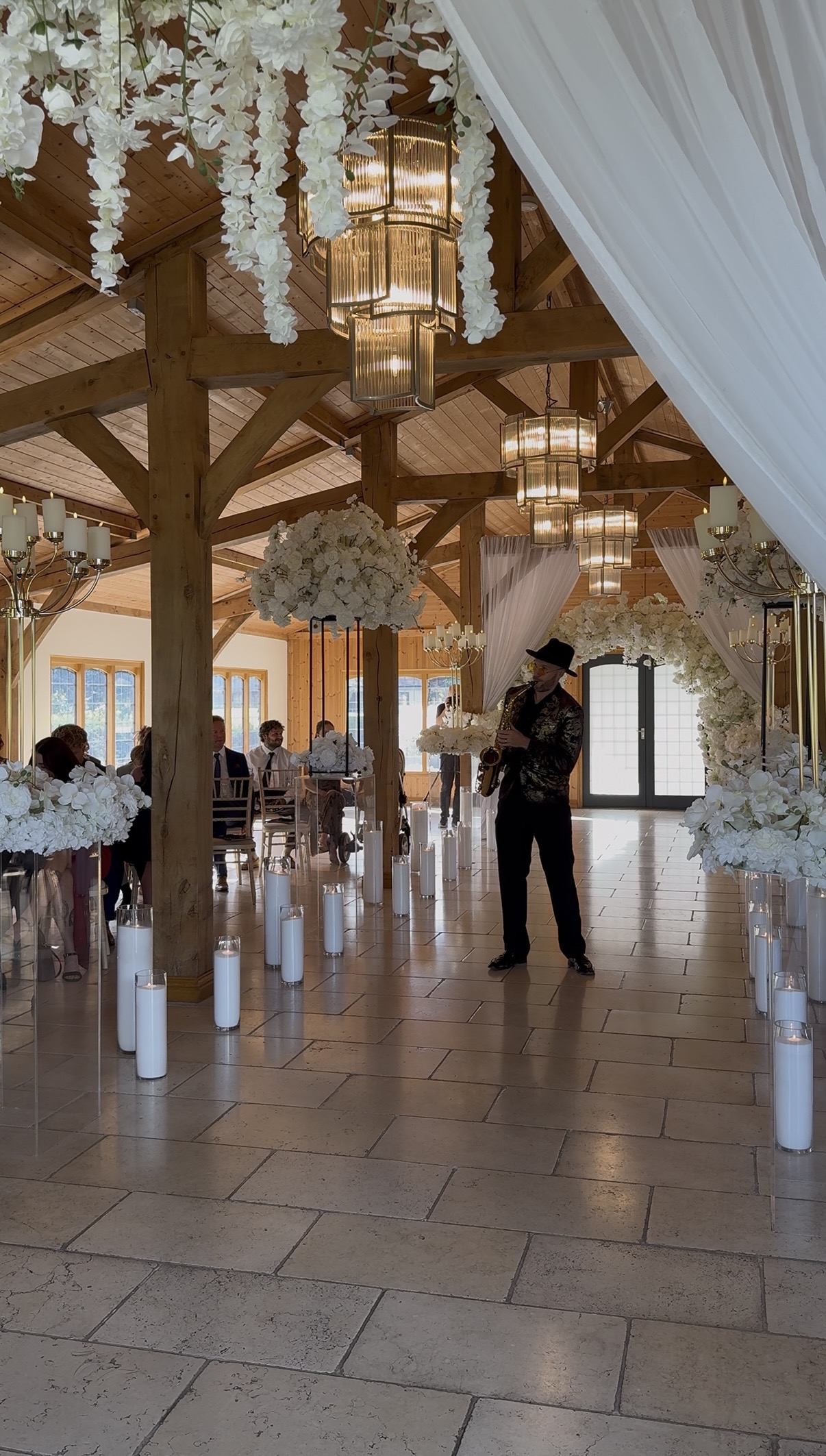 Spencer playing saxophone in the ceremony aisle at Colshaw Hall