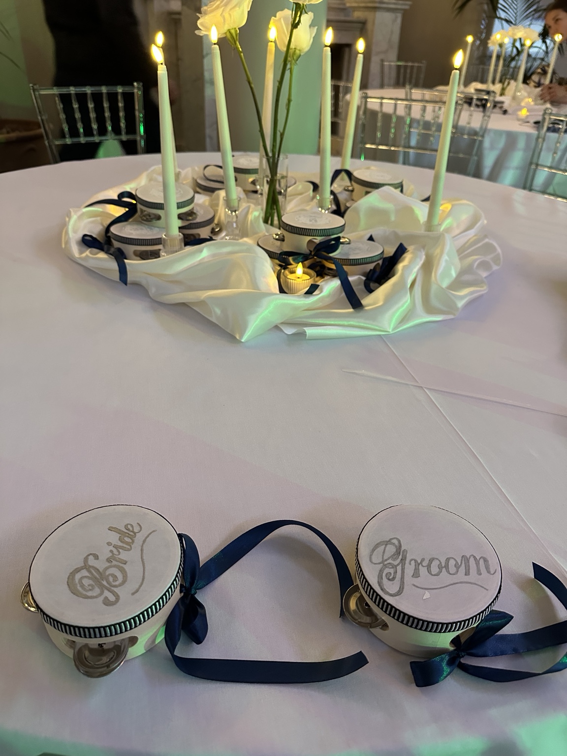 Personalised bride and groom tambourines on a wedding table