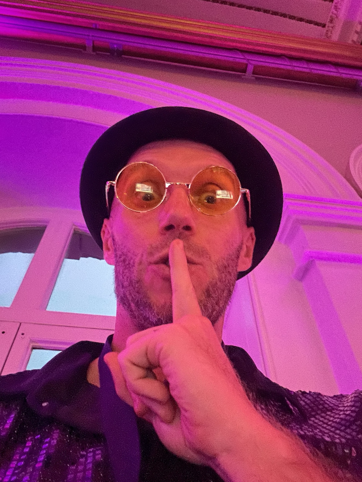 Spencer making a quiet gesture before his surprise sax appearance