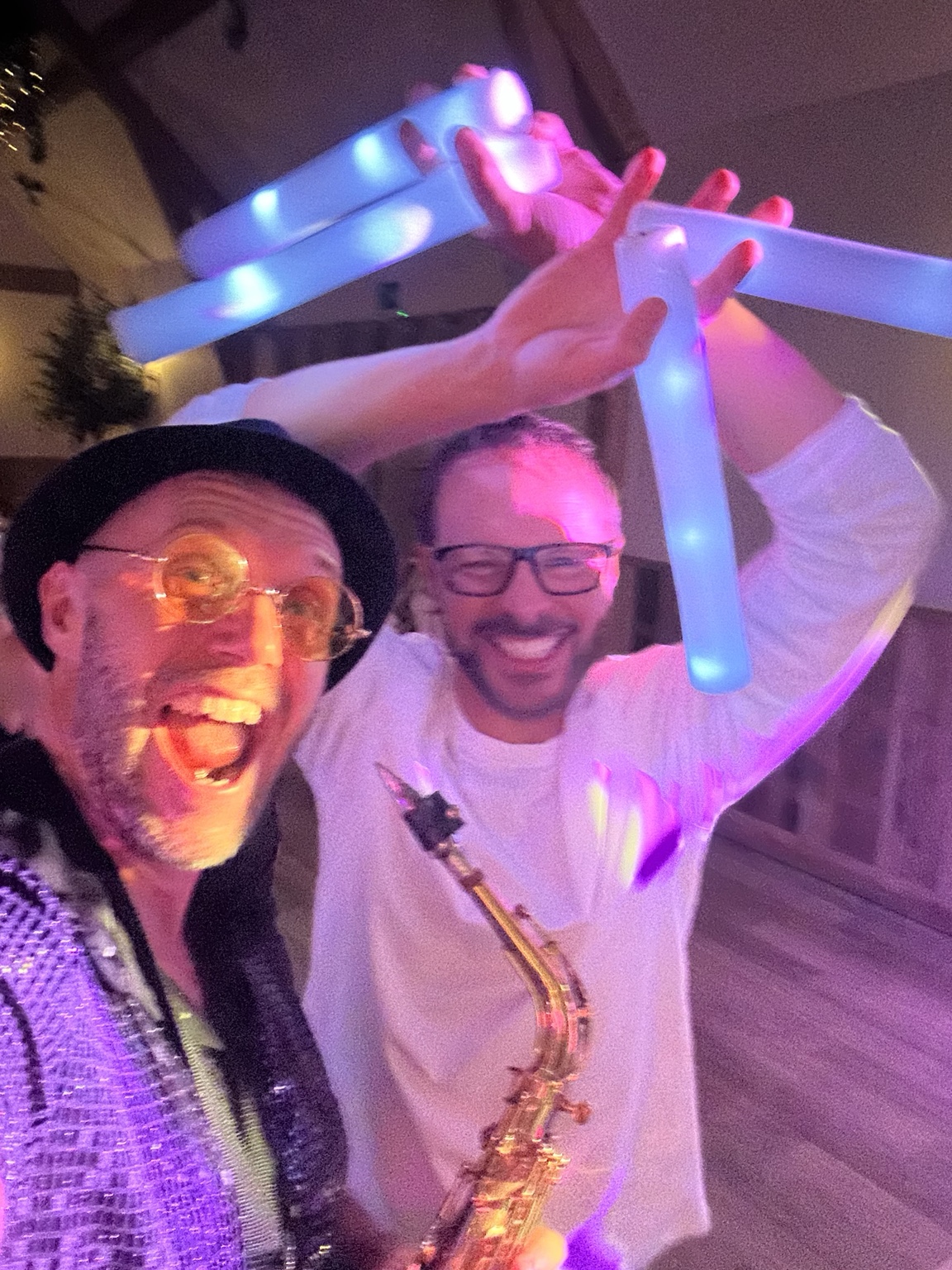 Spencer and a wedding guest enjoying the evening with glow sticks