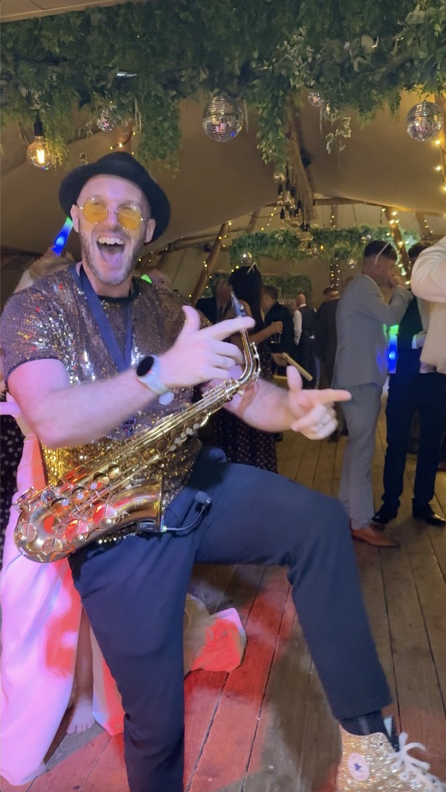 Spencer joining the party with his saxophone at Rylands Farmhouse Weddings