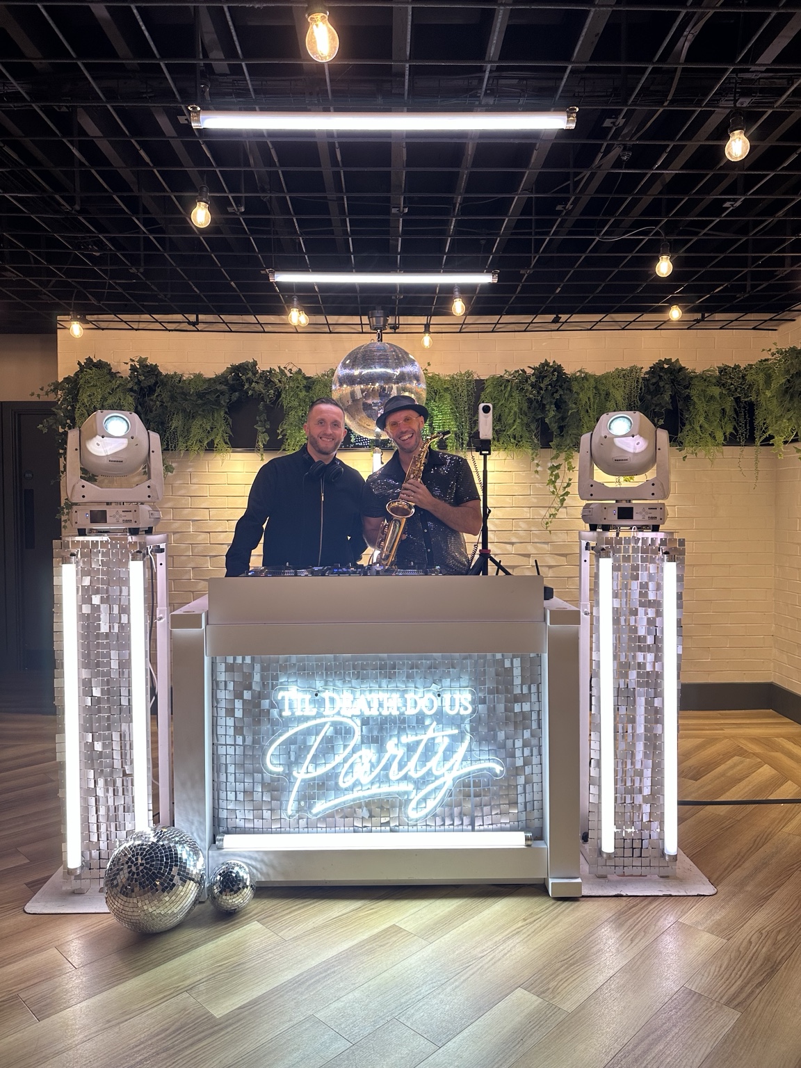 Spencer and DJ Lee Morgan behind the DJ booth at Whistle Barns