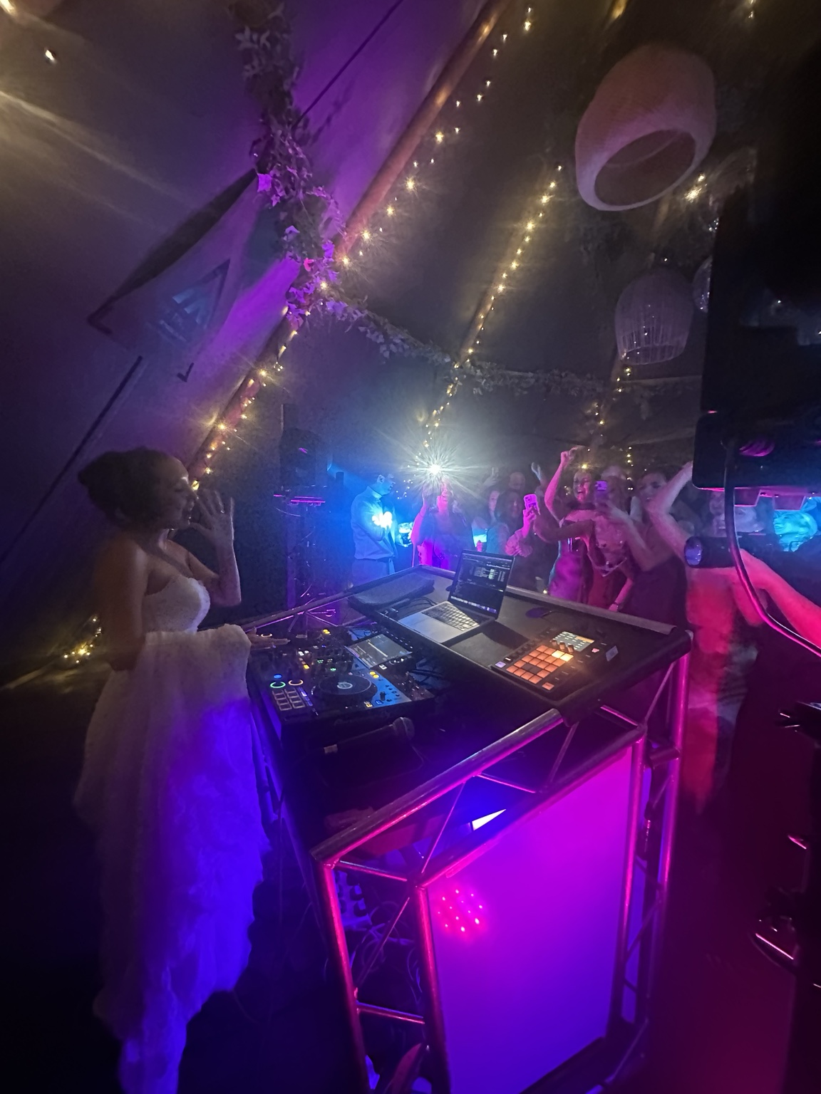 Amber celebrating behind the DJ decks at her Woodhill Hall wedding